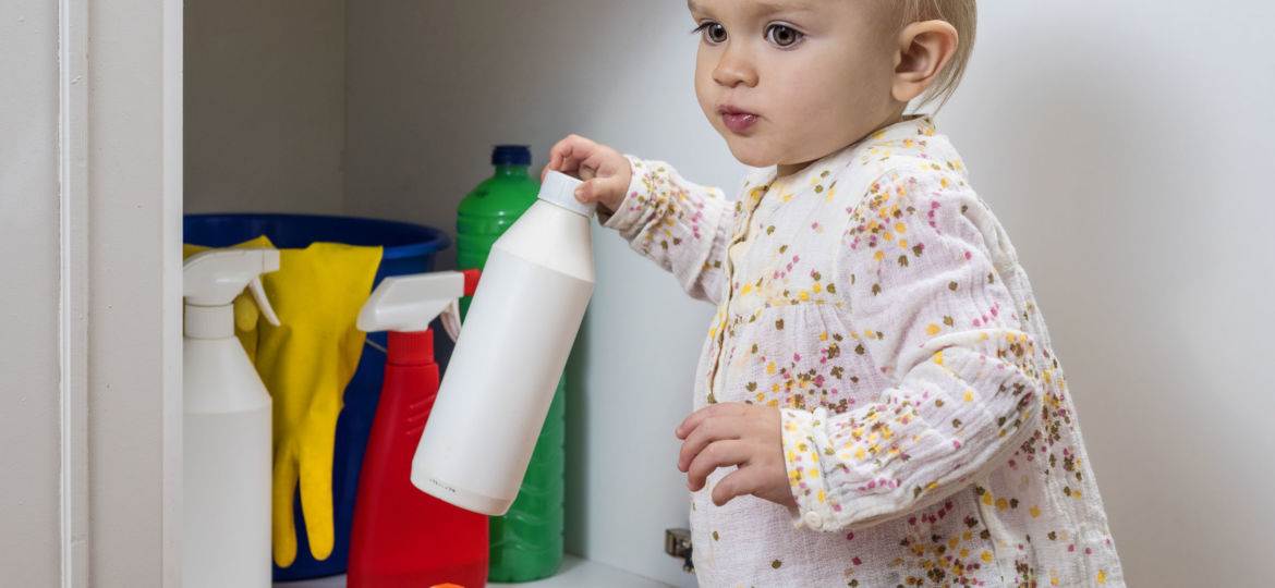 47589874 - toddler playing with household cleaners at home