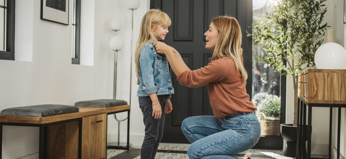 Mother getting her daughter ready