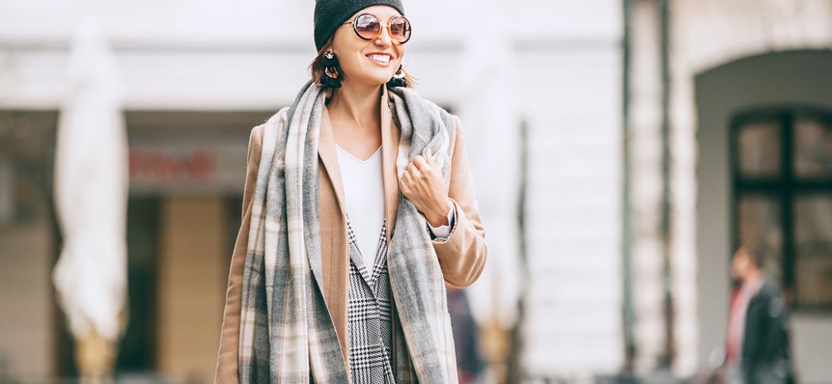 Fashion weared woman walks on city street