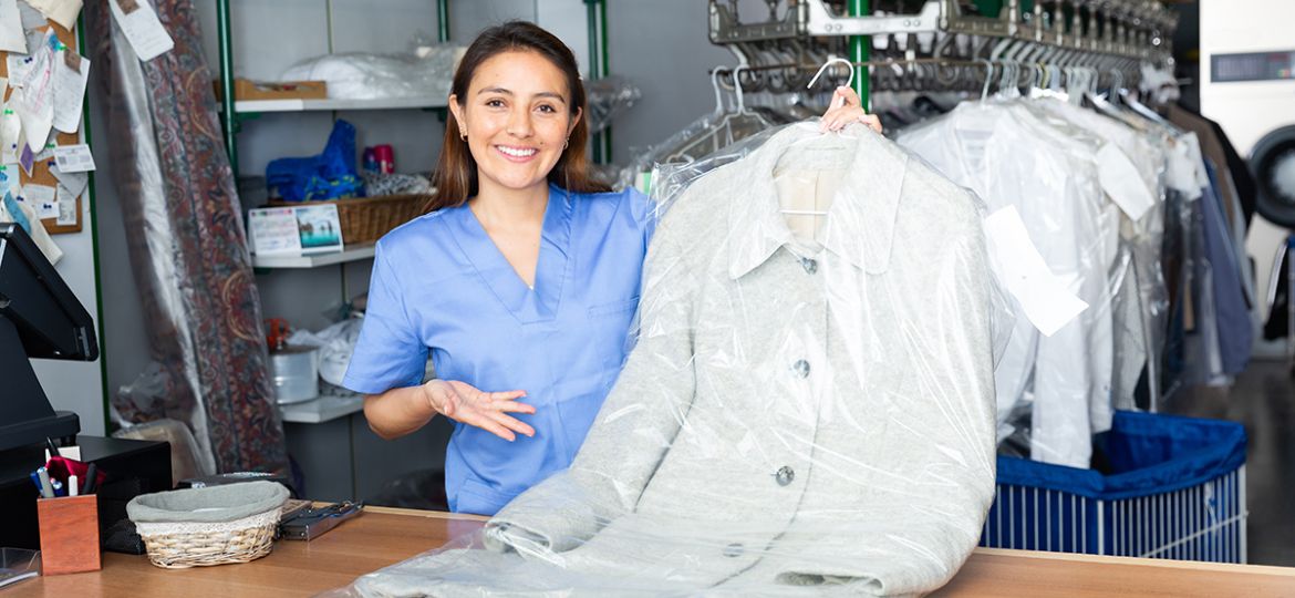 Portrait of woman worker of dry-cleaning facility